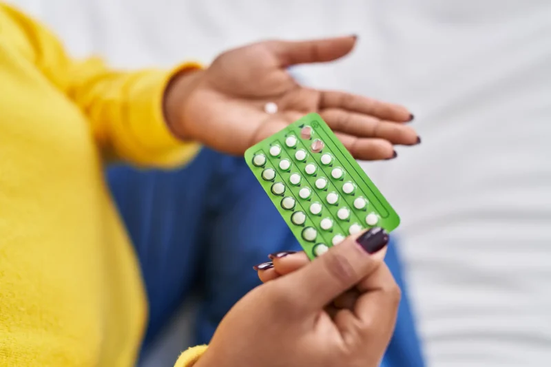 close-up-of-woman-holding-contraceptive-pill-tablet-and-blister-in-hands